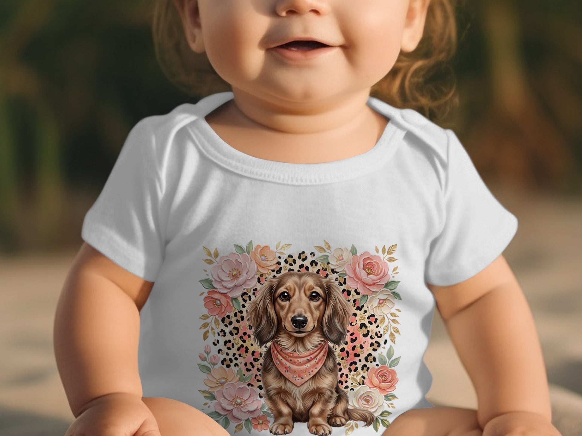 Baby in white bodysuit with dachshund and floral print.