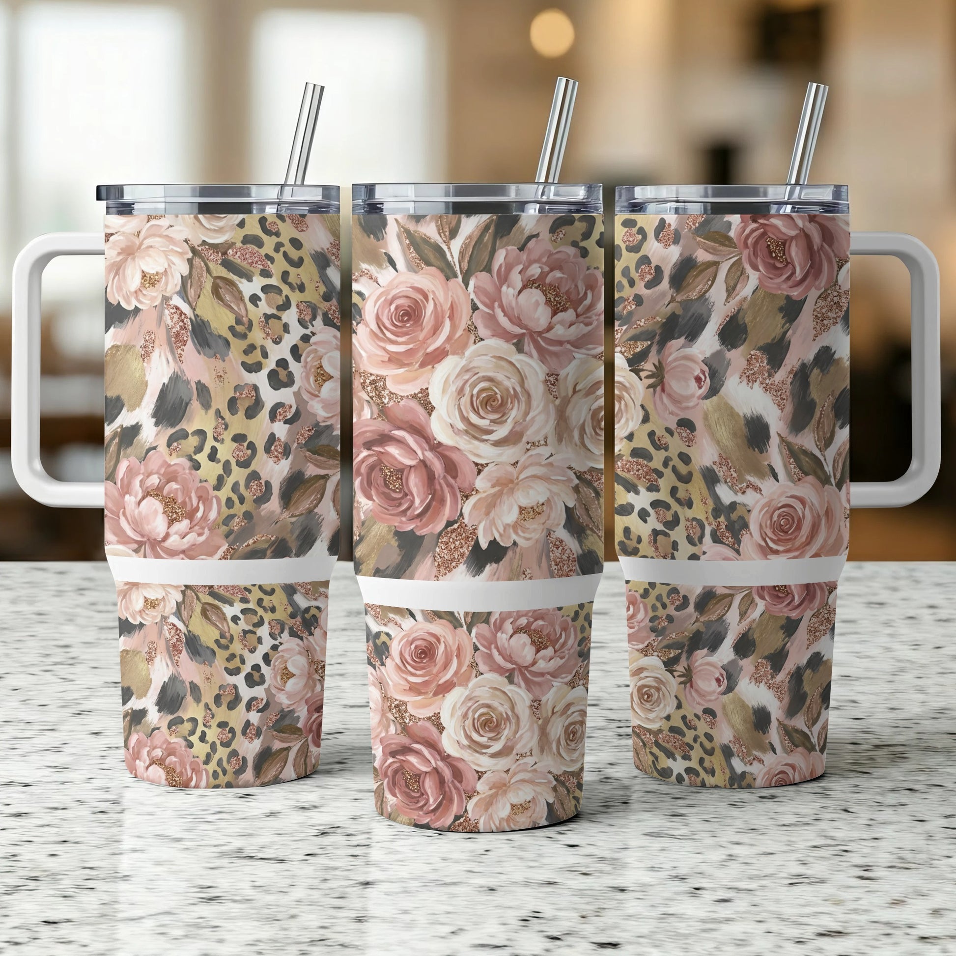 Three floral and leopard print tumblers with handles and straws.