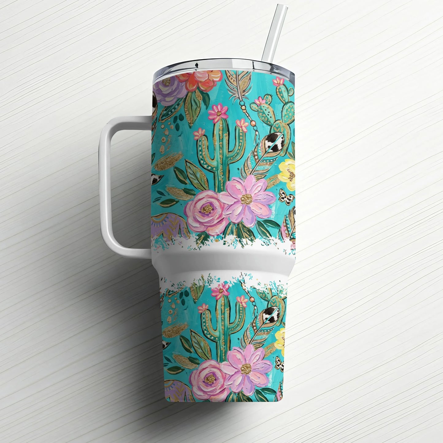 Turquoise tumbler with a floral and cactus pattern and a straw.