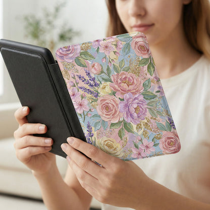 Floral patterned e-reader cover with gold glitter accents in woman's hands.