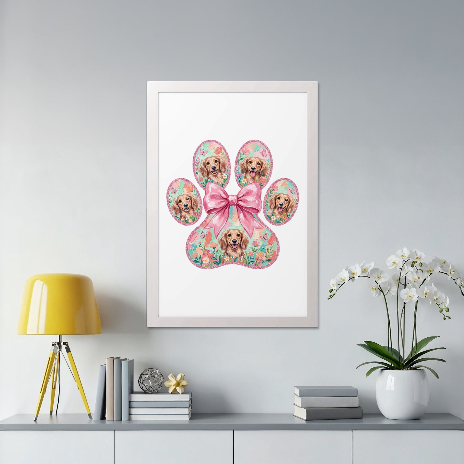 Framed artwork featuring a paw print with dog portraits and floral accents.