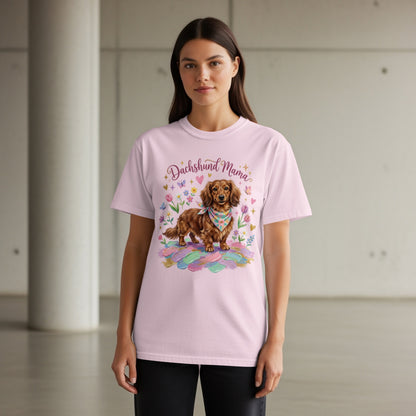 Dachshund Mama graphic on a light pink t-shirt with a dog and feathers.