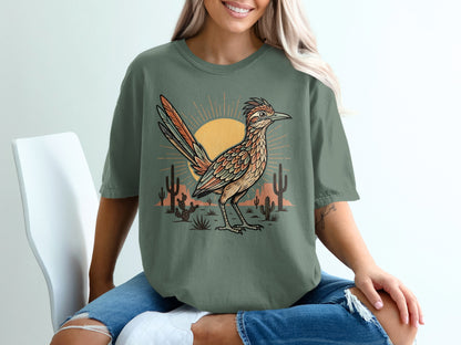 Green t-shirt with desert roadrunner, cacti, and sun graphic.