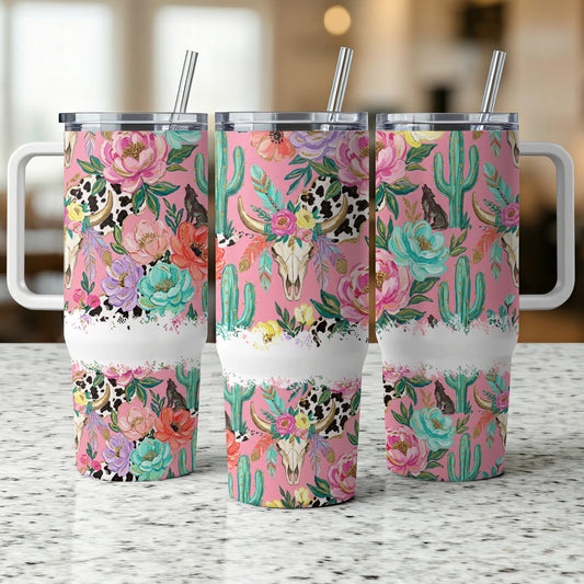 Pink tumbler with cow skull and floral, cactus pattern.