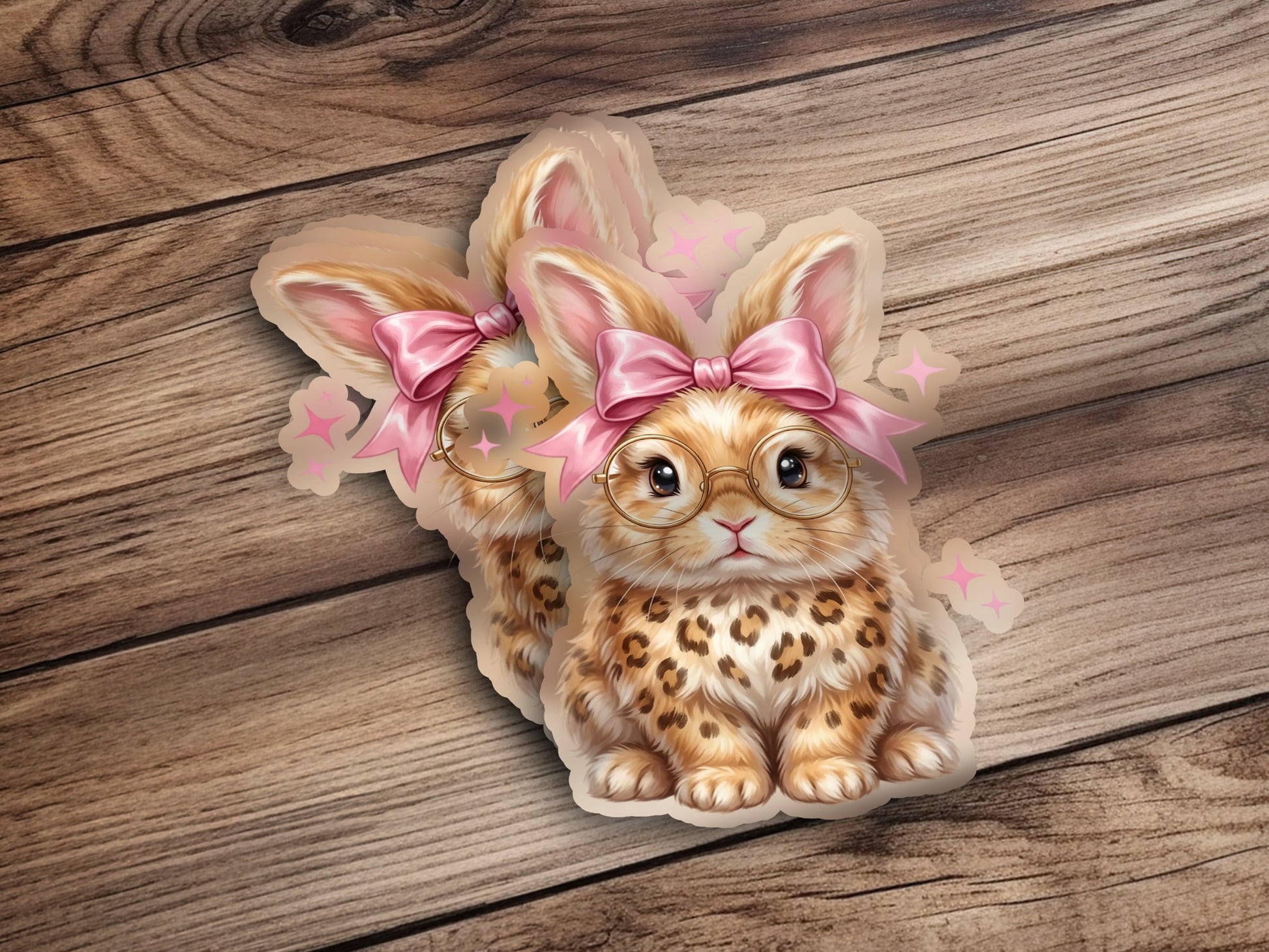 Two cute bunnies with glasses and pink bows on wooden background.
