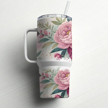 White tumbler with pink floral pattern and handle, with a straw.
