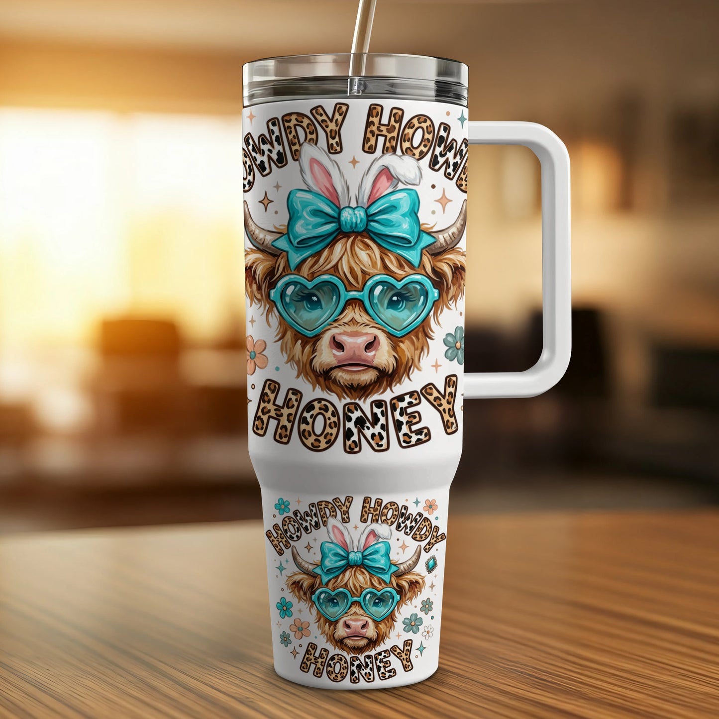 Cow print tumbler with heart glasses and bunny ears reading "Howdy Honey".