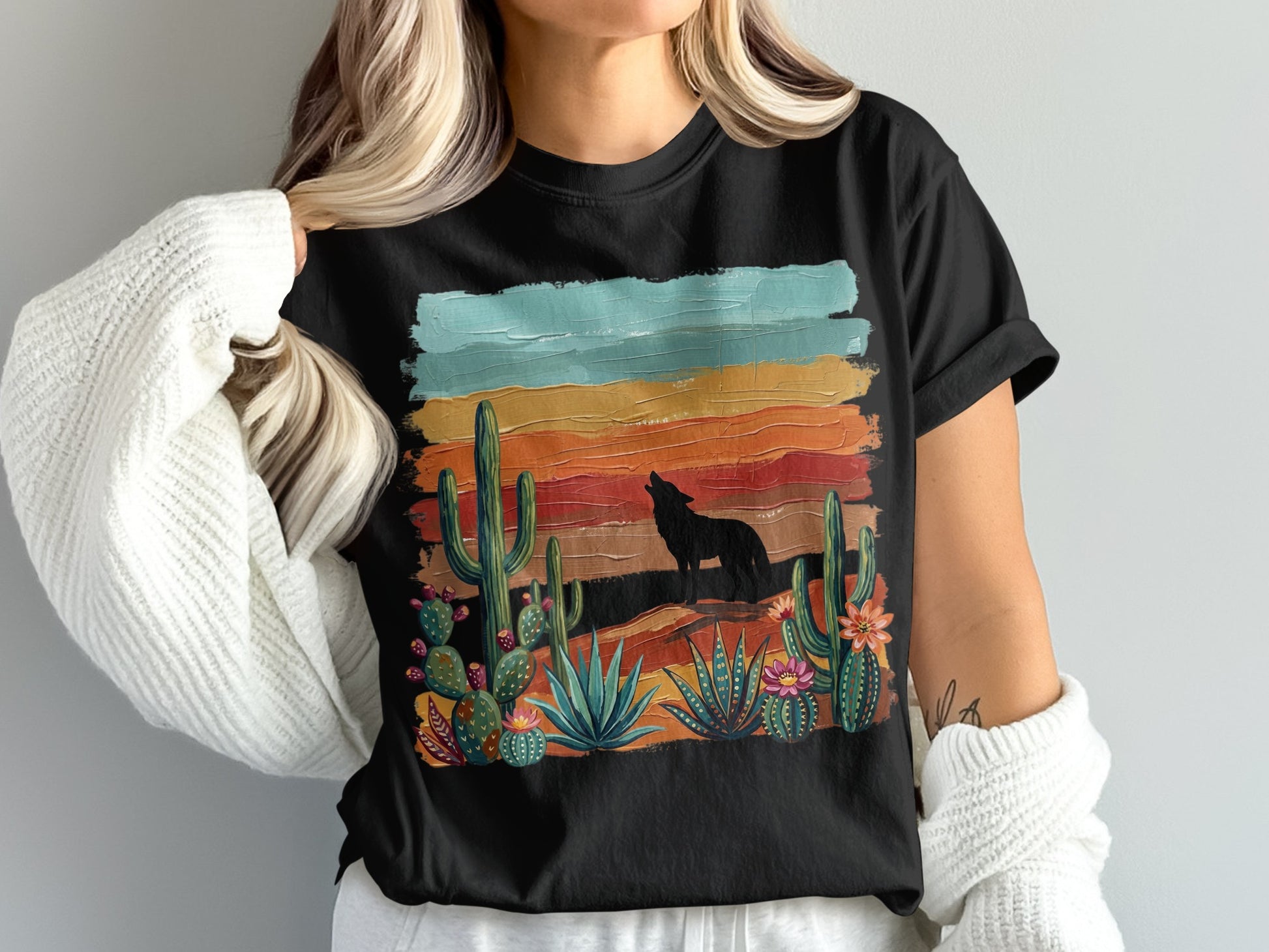 Black t-shirt with desert landscape, cactus, and wolf silhouette design.