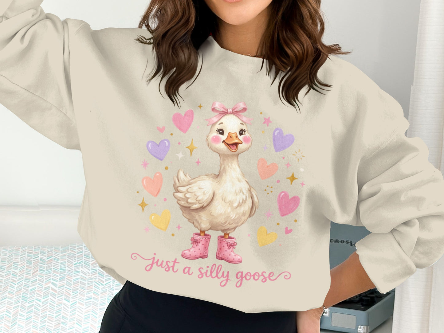 Cream sweatshirt with a smiling goose in pink boots and hearts.