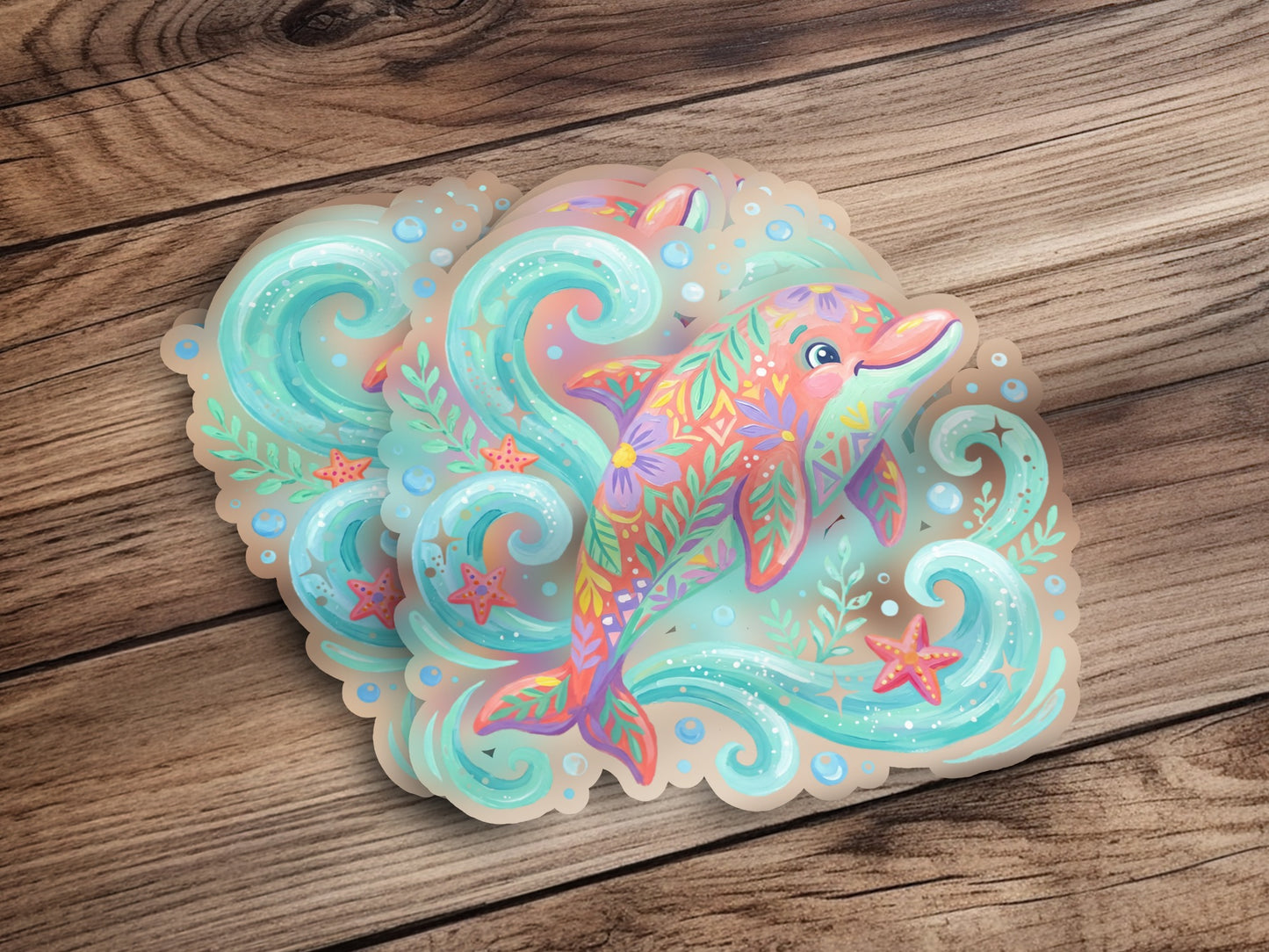 Whimsical dolphin sticker with colorful floral patterns on a wooden background.