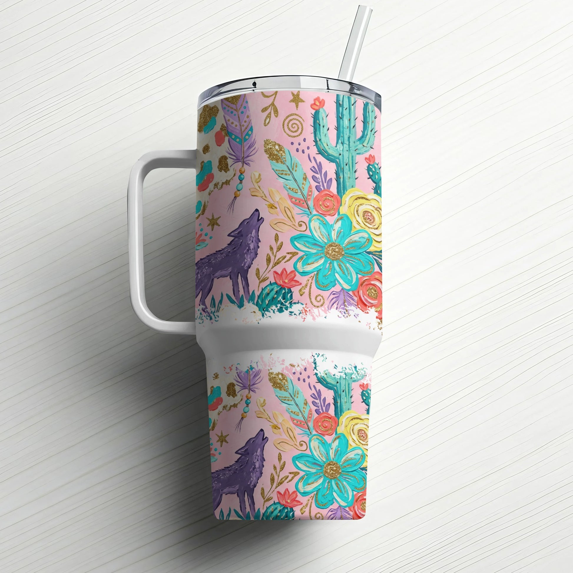 Pink tumbler with wolf, cactus, and floral desert design, includes straw.