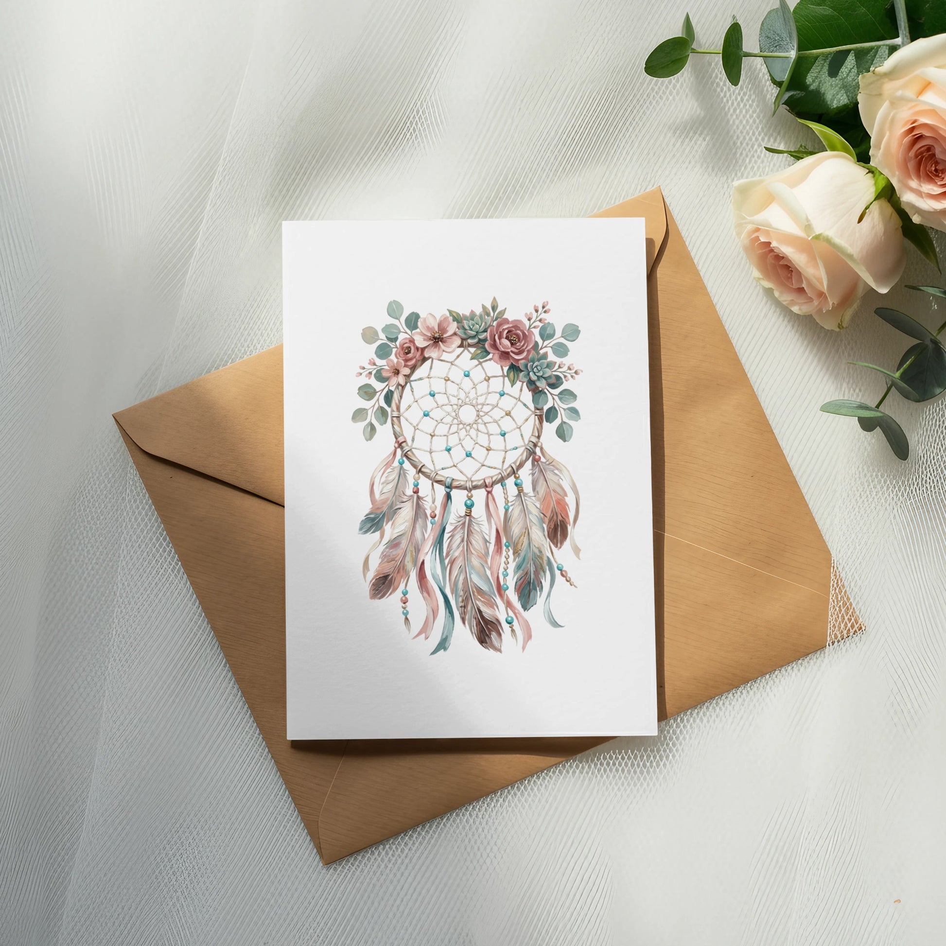 Dreamcatcher with feathers and flowers on a card with envelope and roses.