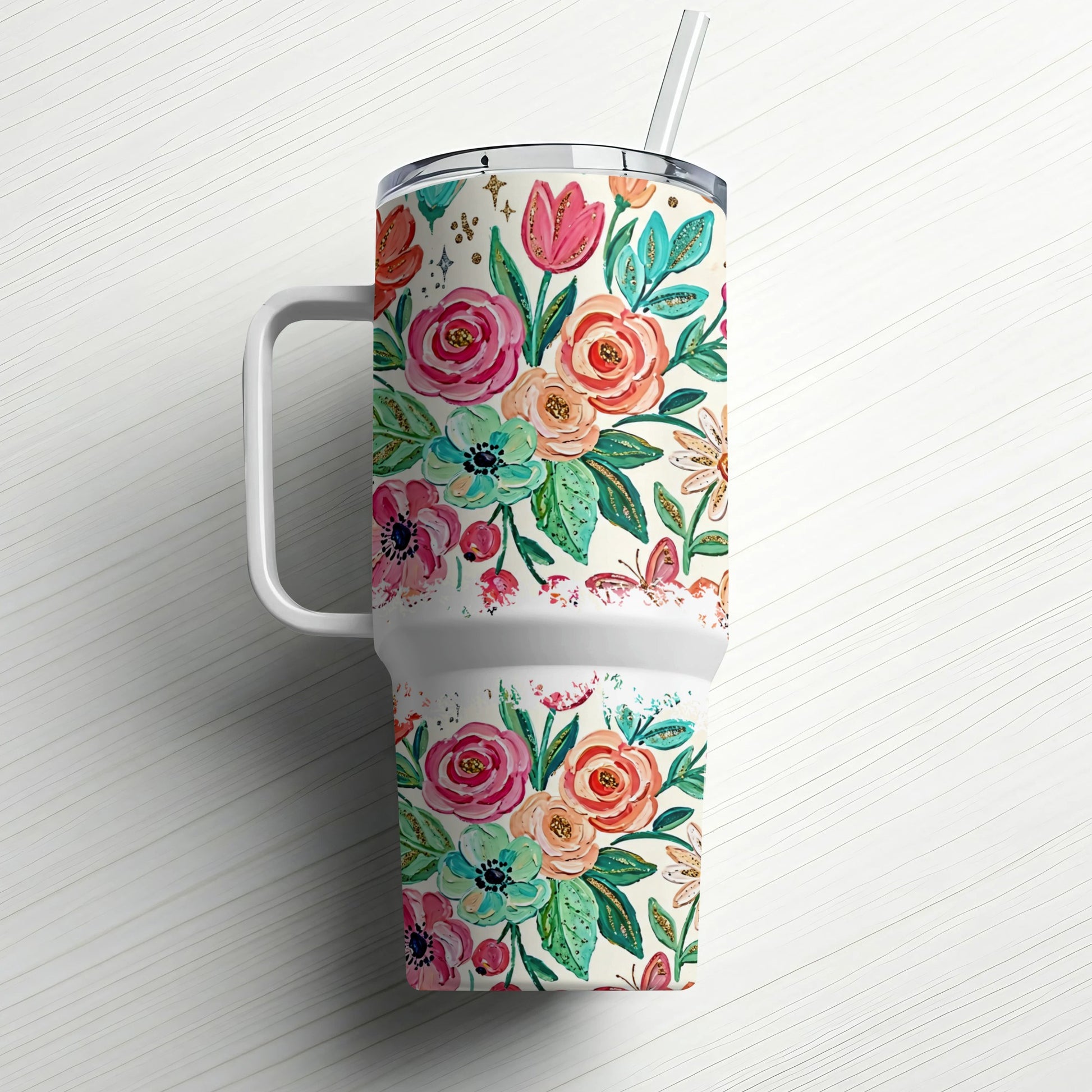 Floral print tumbler with handle and straw on white background.