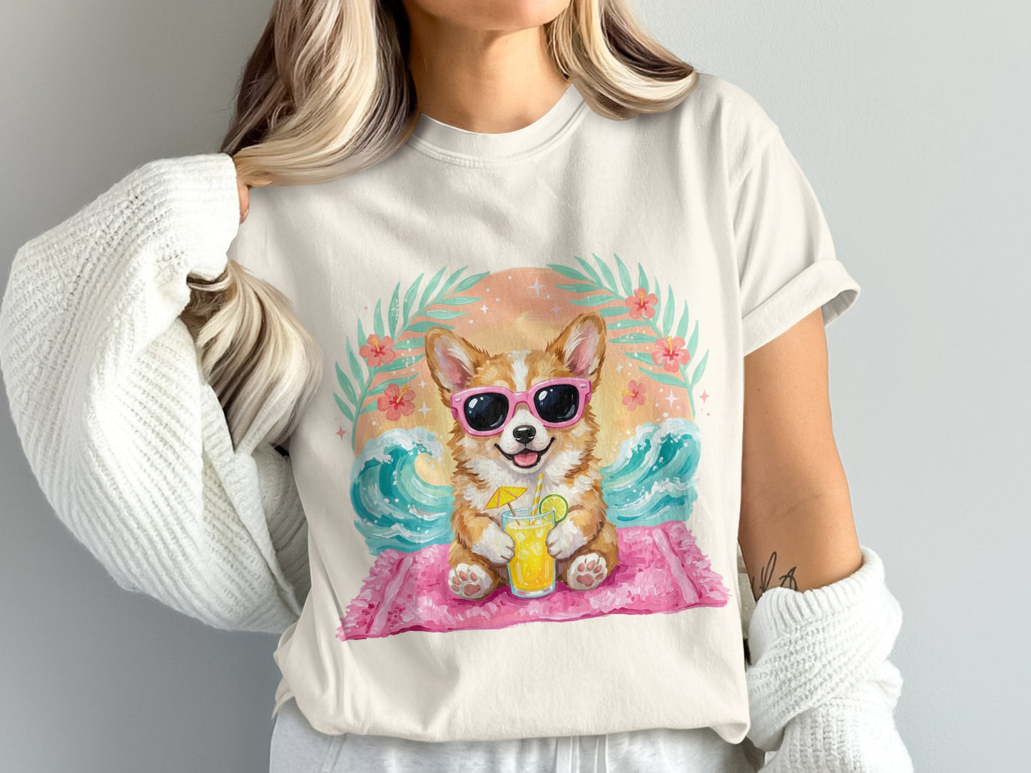 Corgi in sunglasses with a drink on a beach, wearing a white t-shirt.