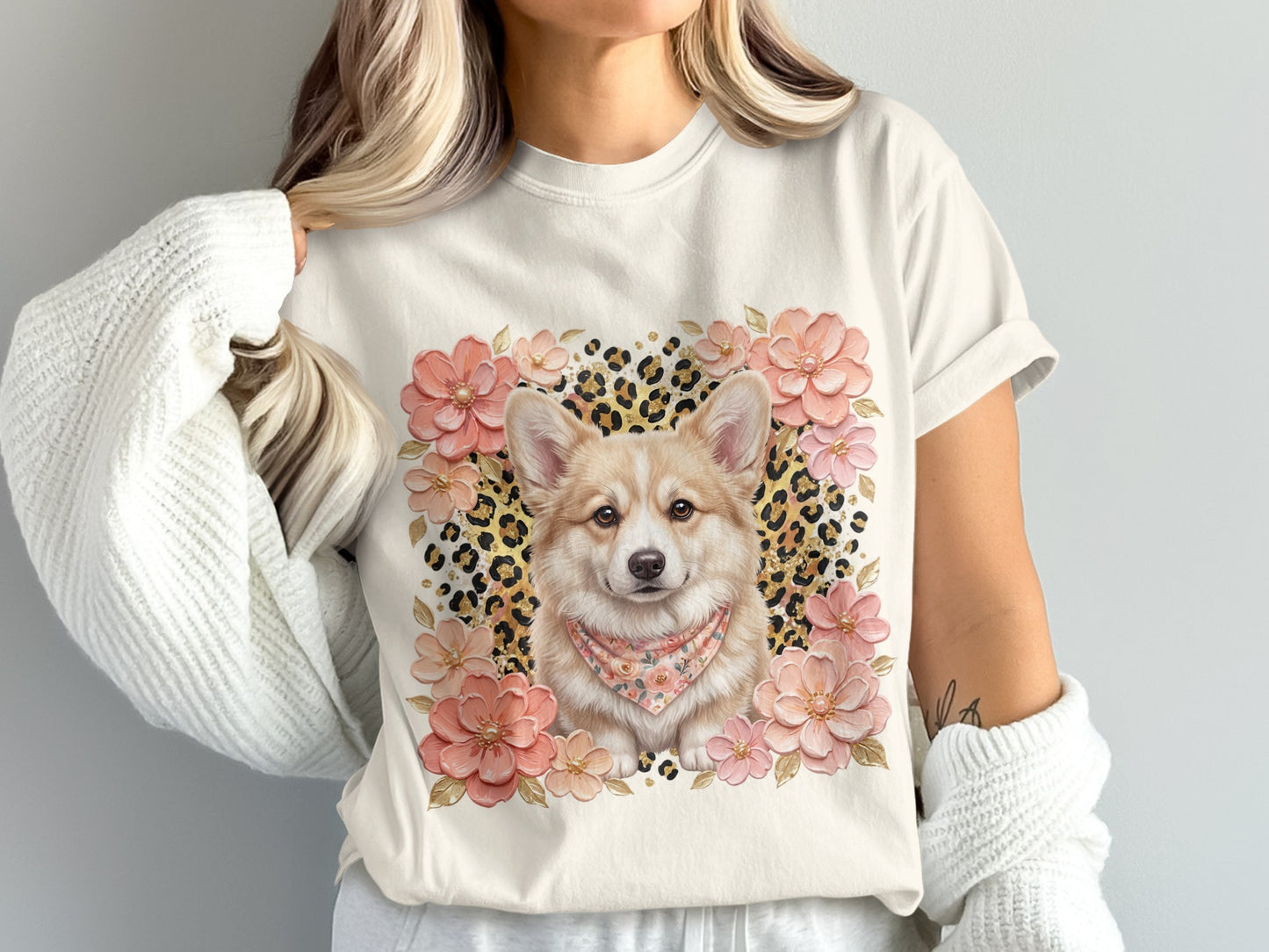 Cream t-shirt with corgi wearing bandana, surrounded by flowers and leopard print.
