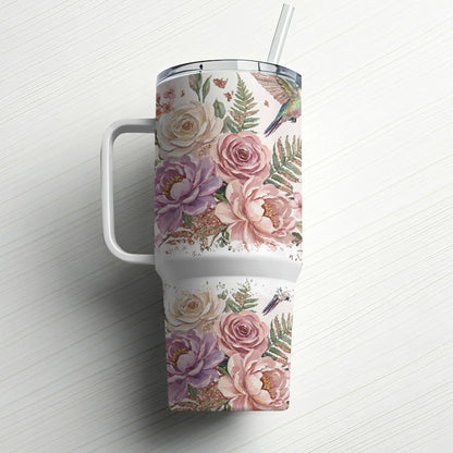 Floral tumbler with hummingbirds and ferns, featuring a straw.