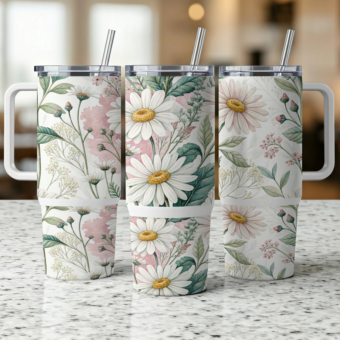Three tumblers with a daisy floral pattern stand on a speckled surface.