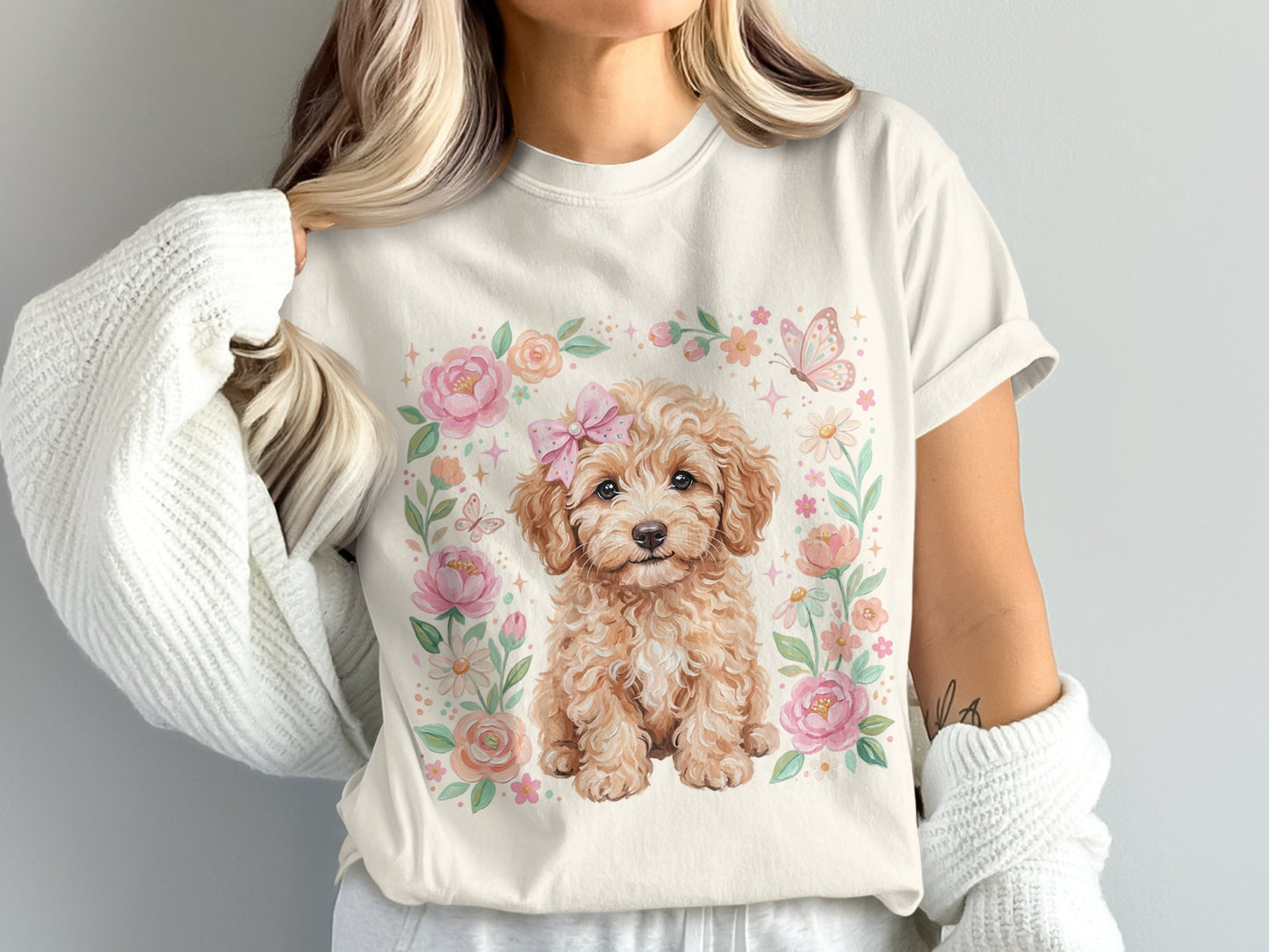 Cream t-shirt with a cute fluffy dog surrounded by pink flowers and a butterfly.