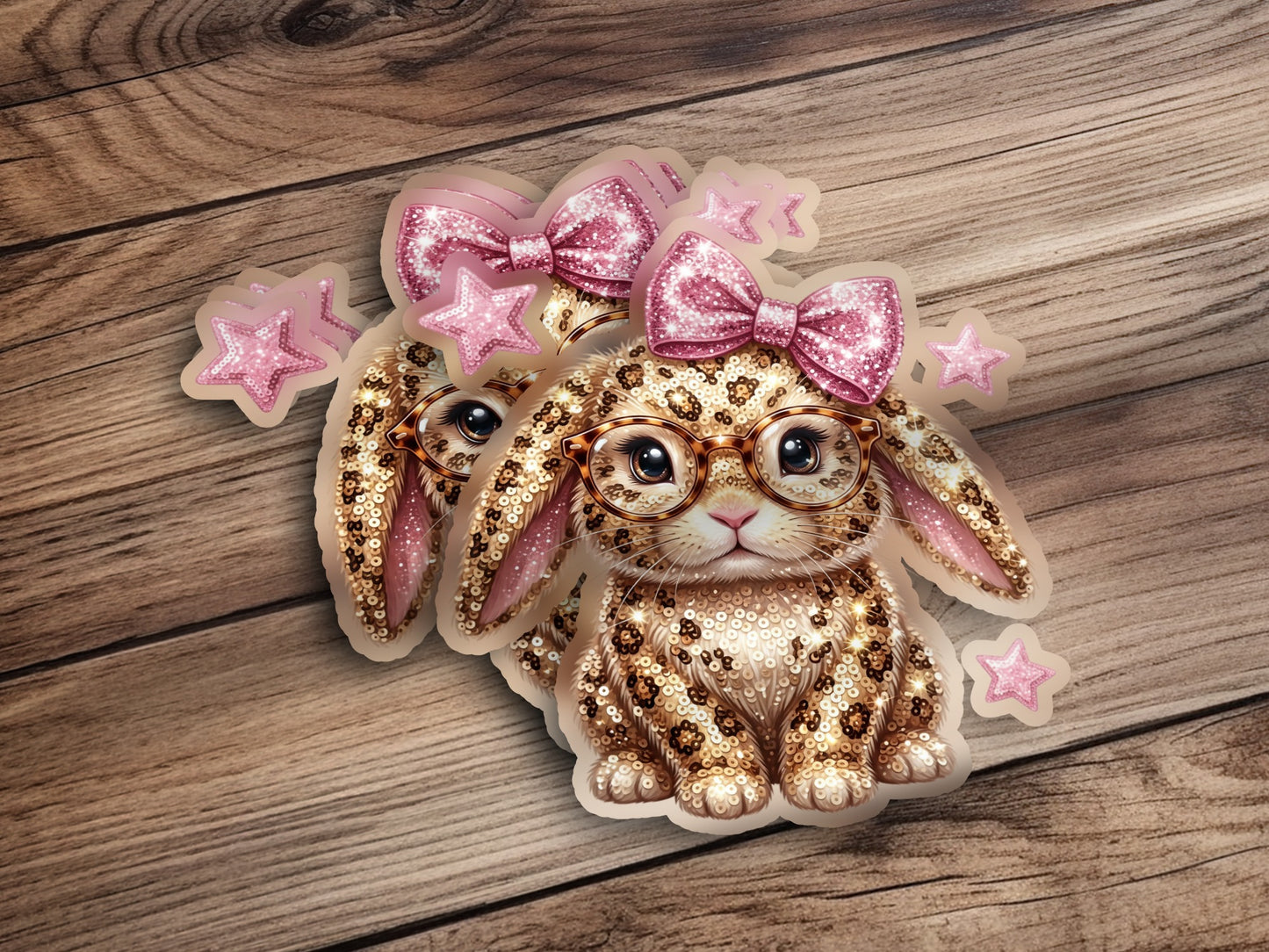 Two cute bunny stickers with glasses, bows, and leopard print on wood.