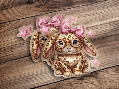 Two cute bunny stickers with glasses, bows, and leopard print on wood.