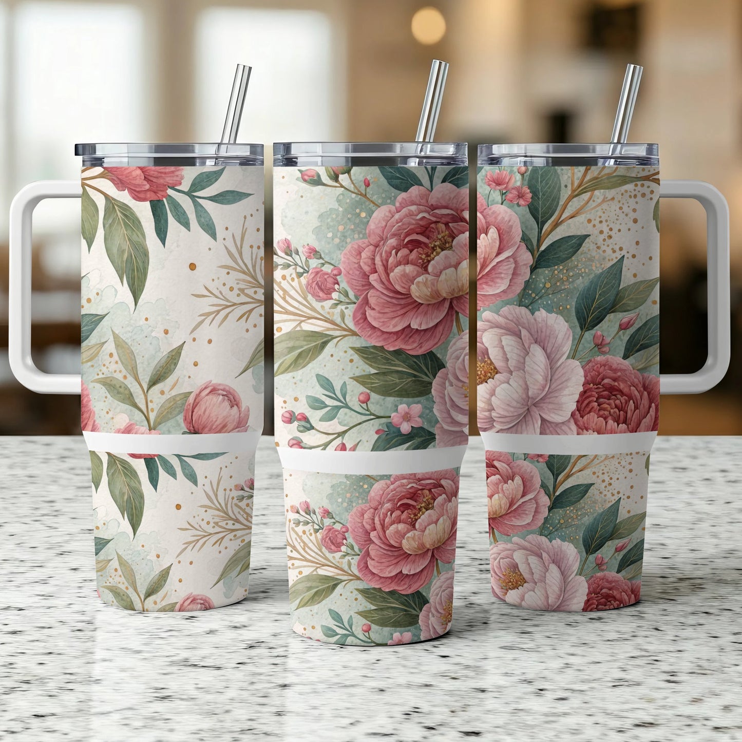Three floral tumblers with handles and straws on a speckled countertop.
