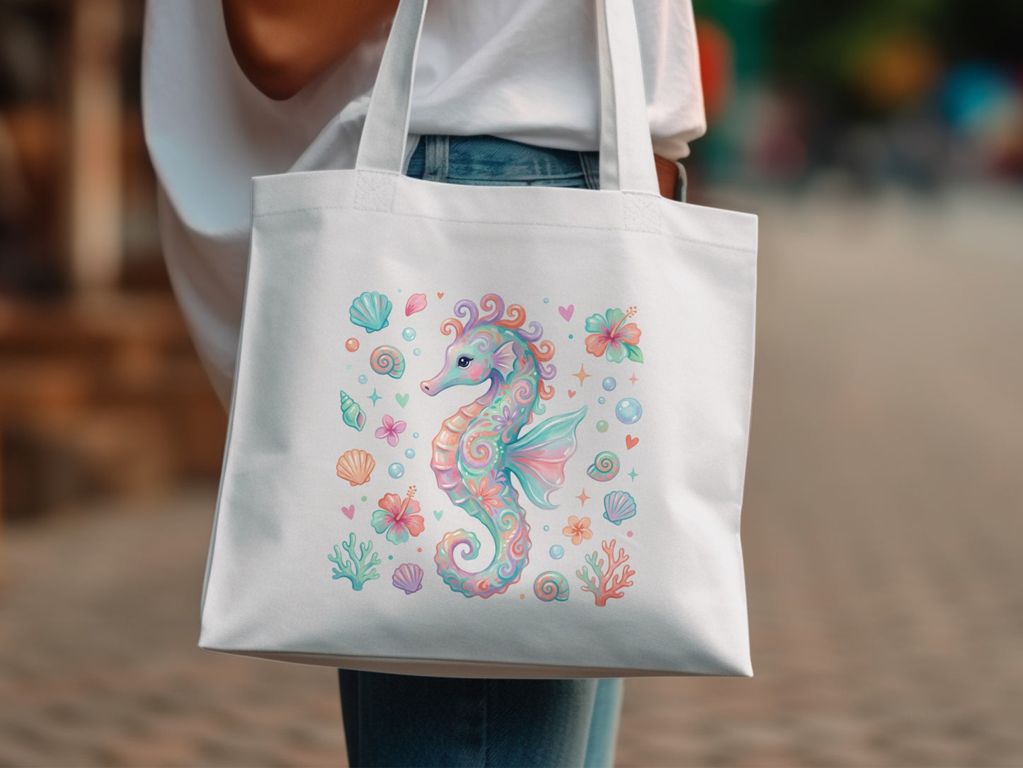 White tote bag with pastel seahorse and seashell illustration.
