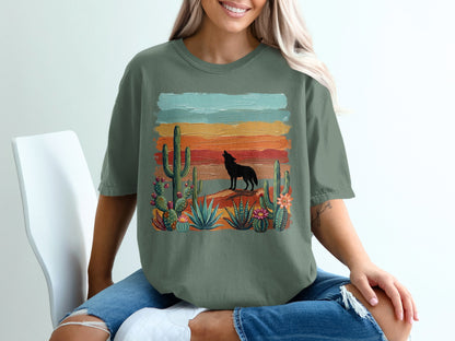 Woman wearing a t-shirt with a silhouette of a wolf against a desert sunset.