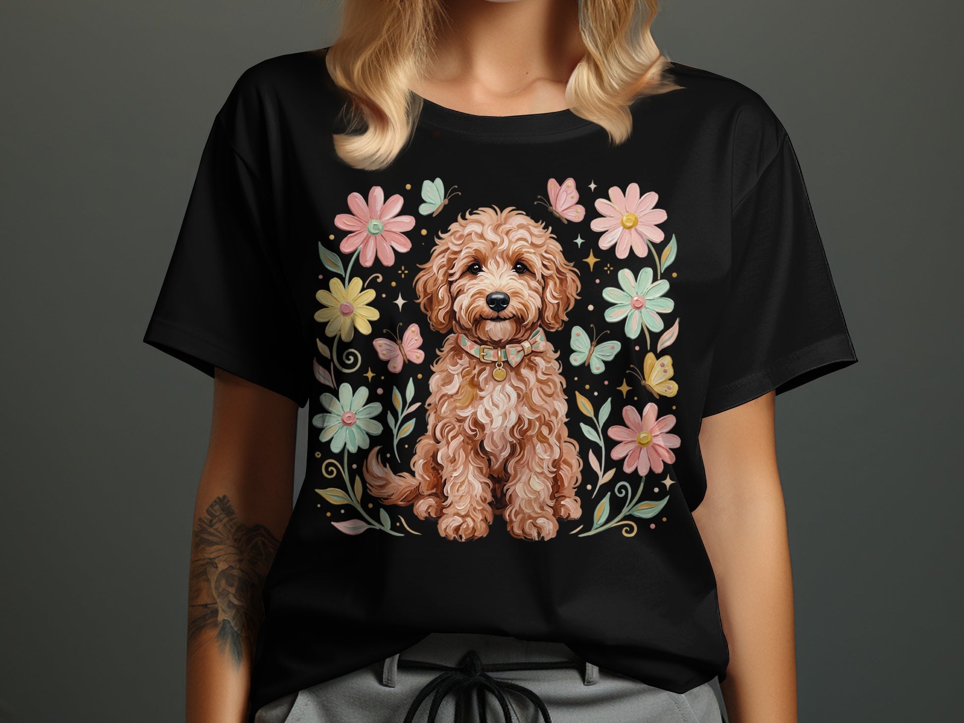 Black t-shirt featuring a fluffy brown dog surrounded by flowers and butterflies.