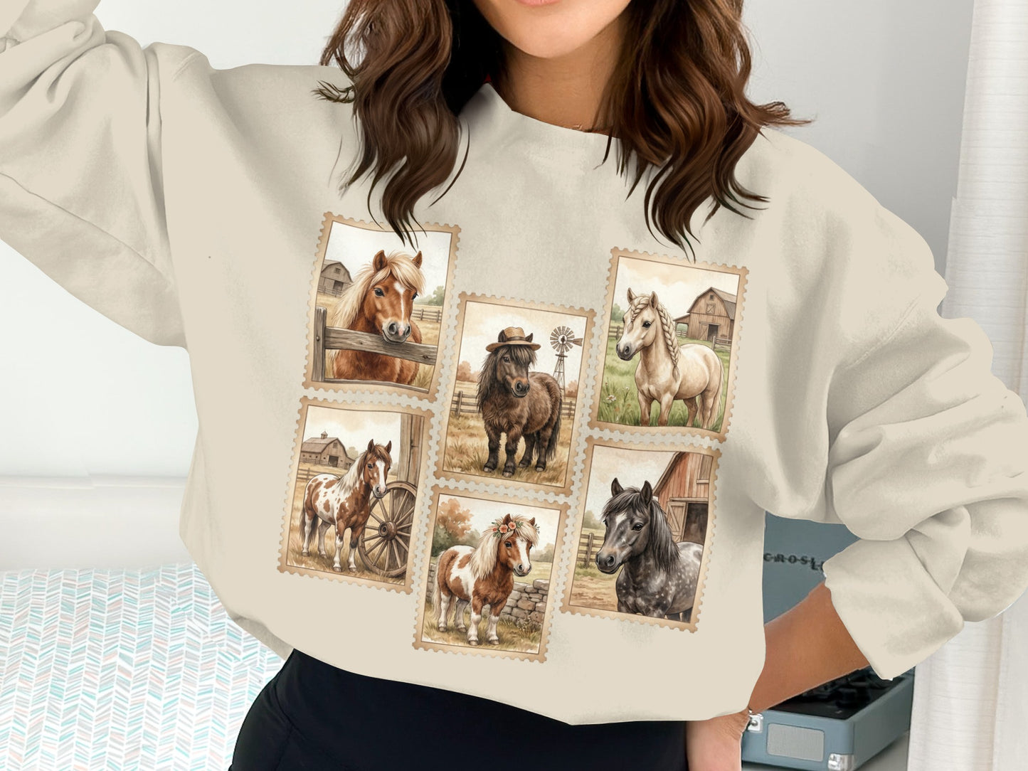 Crewneck sweatshirt with postage stamp-style illustrations of horses and barns.