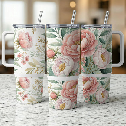 Three floral pattern tumblers with handles and straws on a speckled countertop.