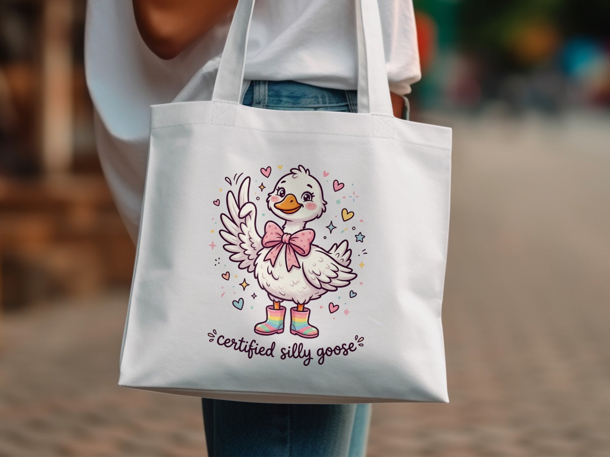 White tote bag with cartoon duck wearing boots and bow, "certified silly goose" text.