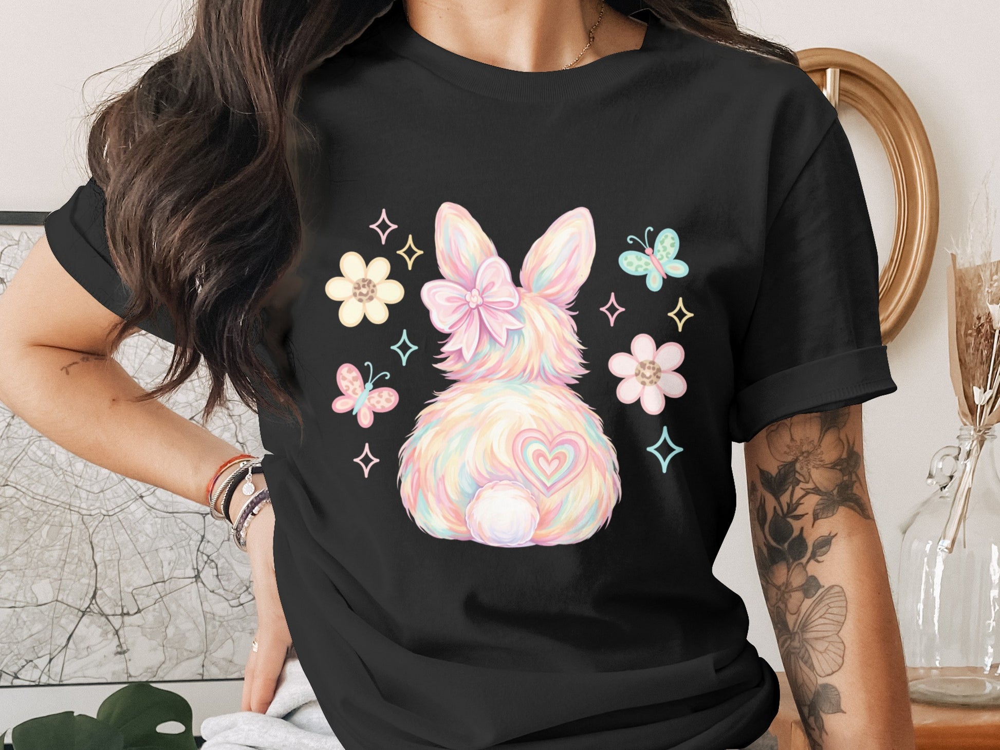 Black t-shirt with pastel bunny, heart, and butterfly graphic.