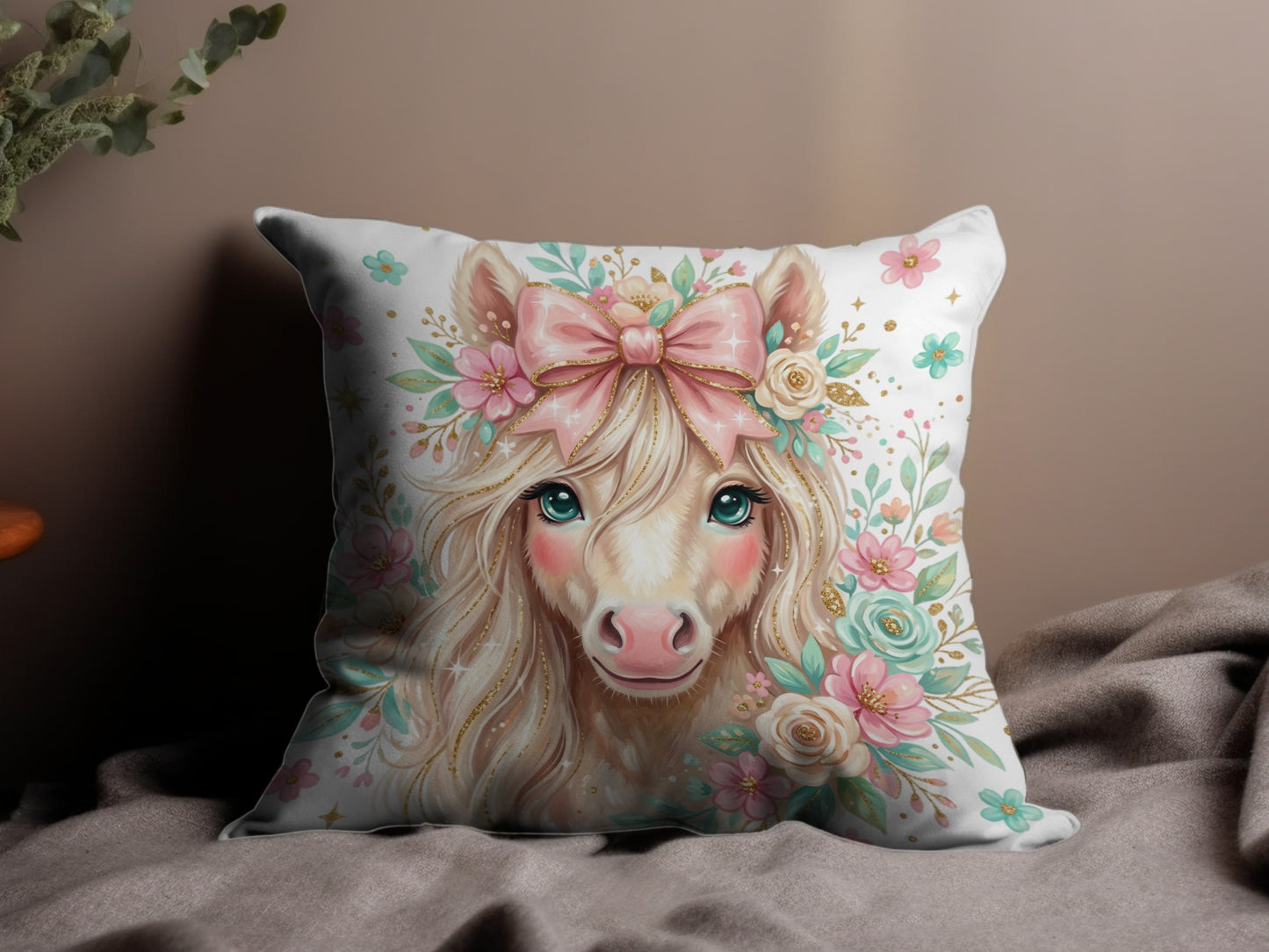 Fawn-colored unicorn with blue eyes, pink bow, and floral wreath on pillow.