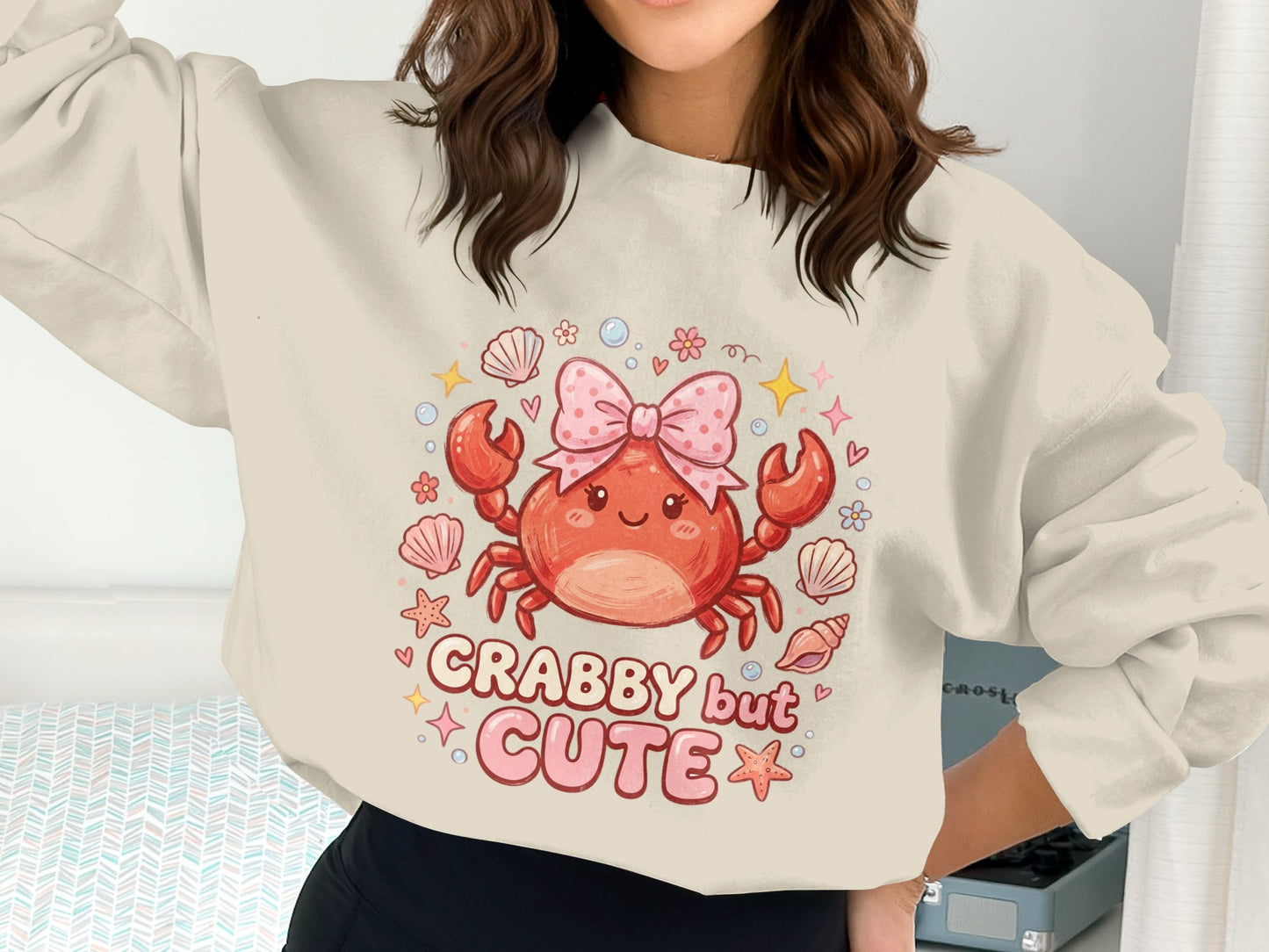 Crabby but cute graphic sweatshirt with pink bow and seashells.