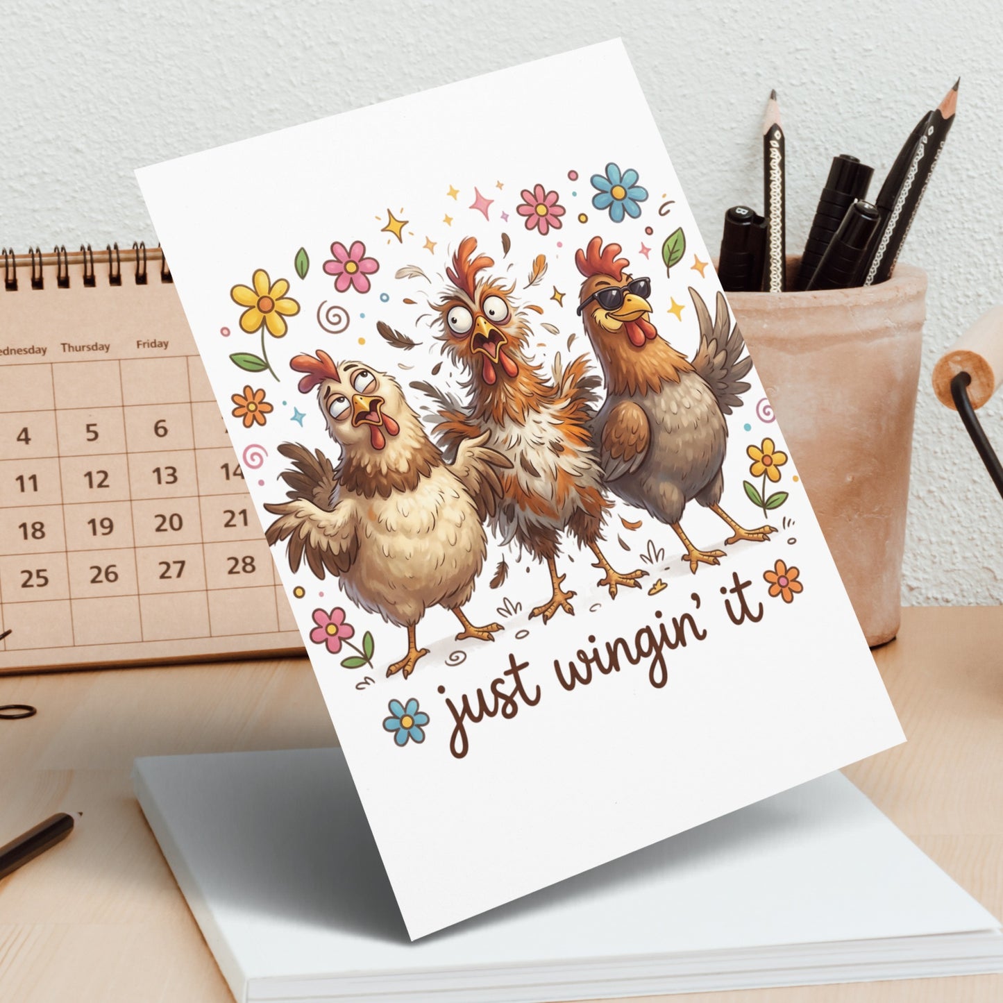 Three cartoon chickens on a card with text "just wingin' it".