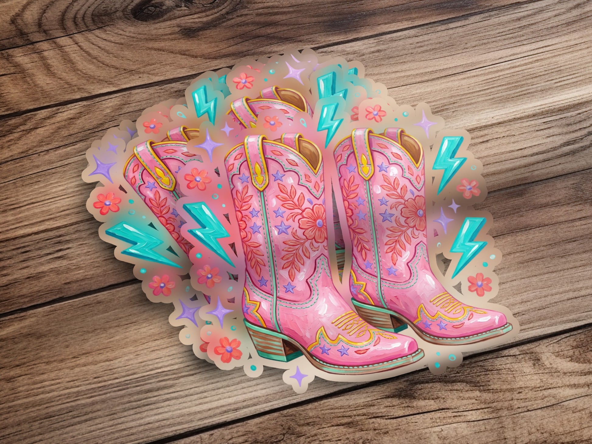 Pink cowboy boots with star and flower embroidery and lightning bolts.