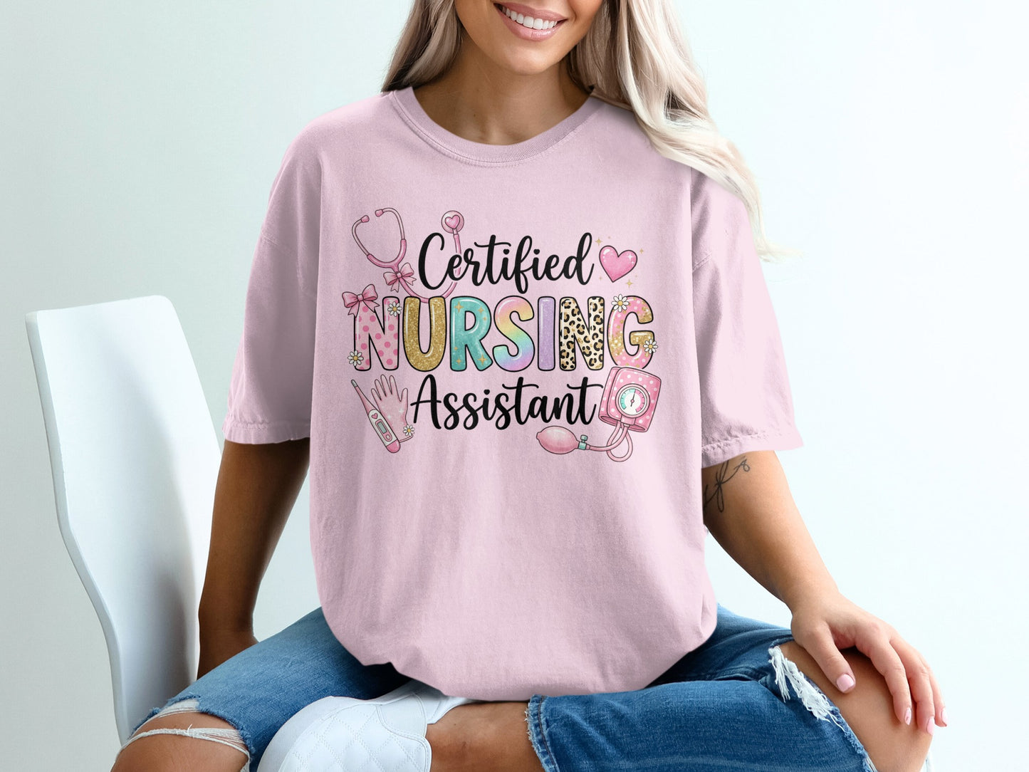 Pink t-shirt with "Certified Nursing Assistant" text and nursing icons.
