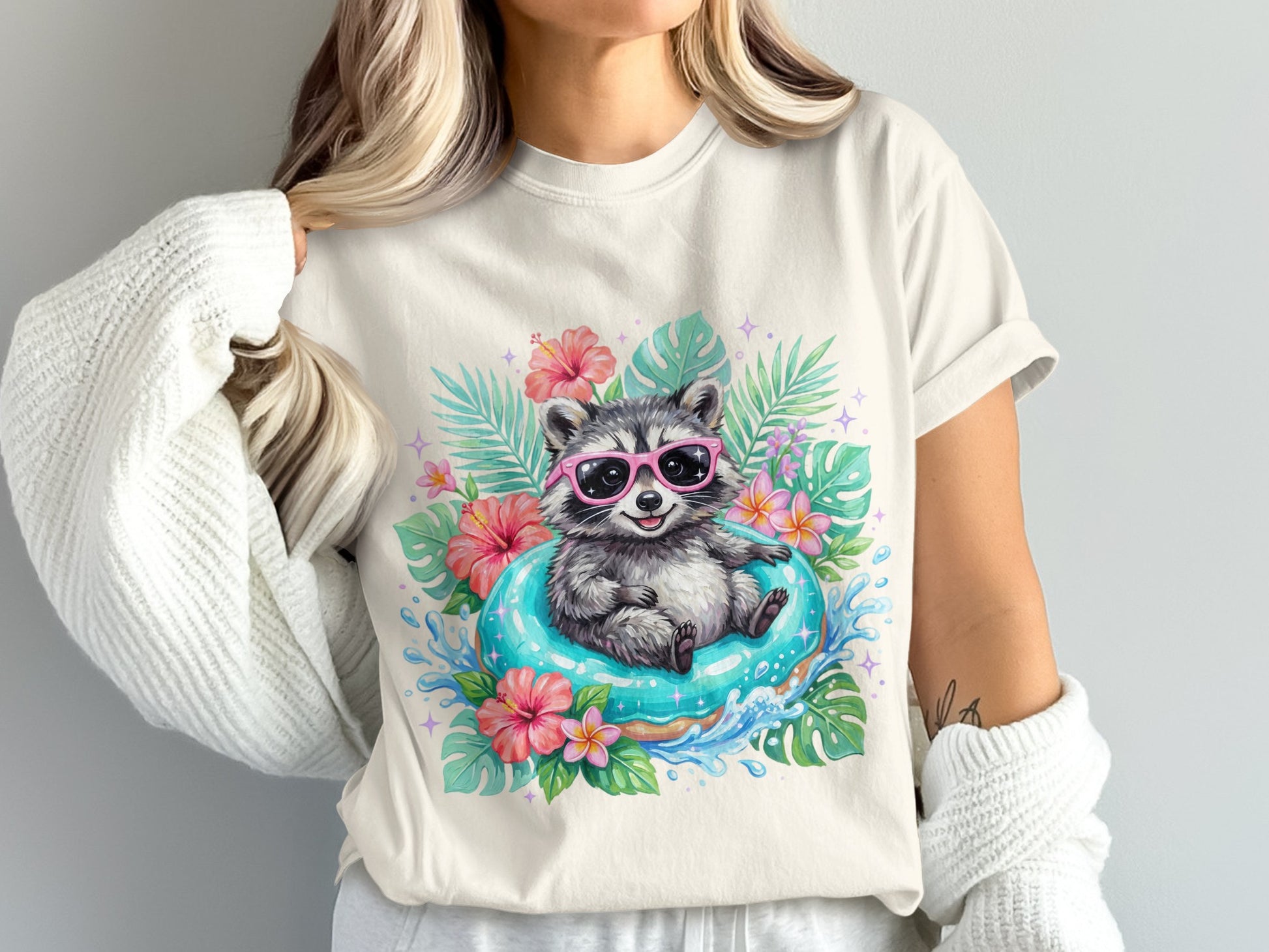 Raccoon wearing pink sunglasses floats on blue inner tube surrounded by tropical leaves and flowers.