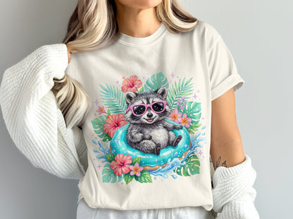 Raccoon wearing pink sunglasses floats on blue inner tube surrounded by tropical leaves and flowers.