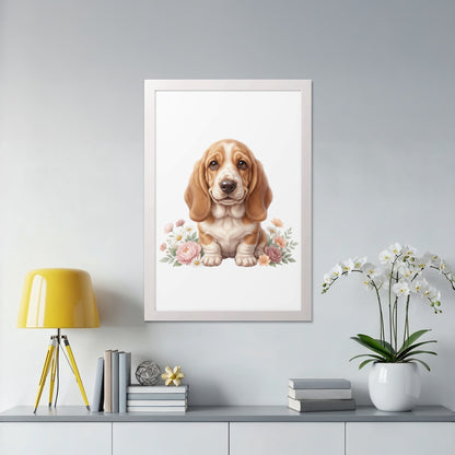 Basset hound puppy sits among pink and white flowers.