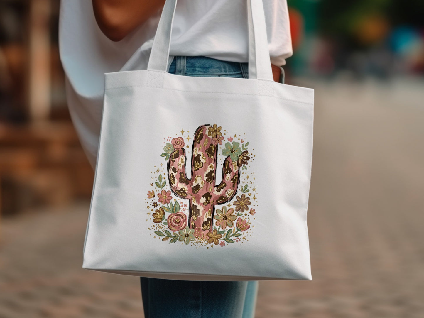 White tote bag with a cowhide and floral cactus design.