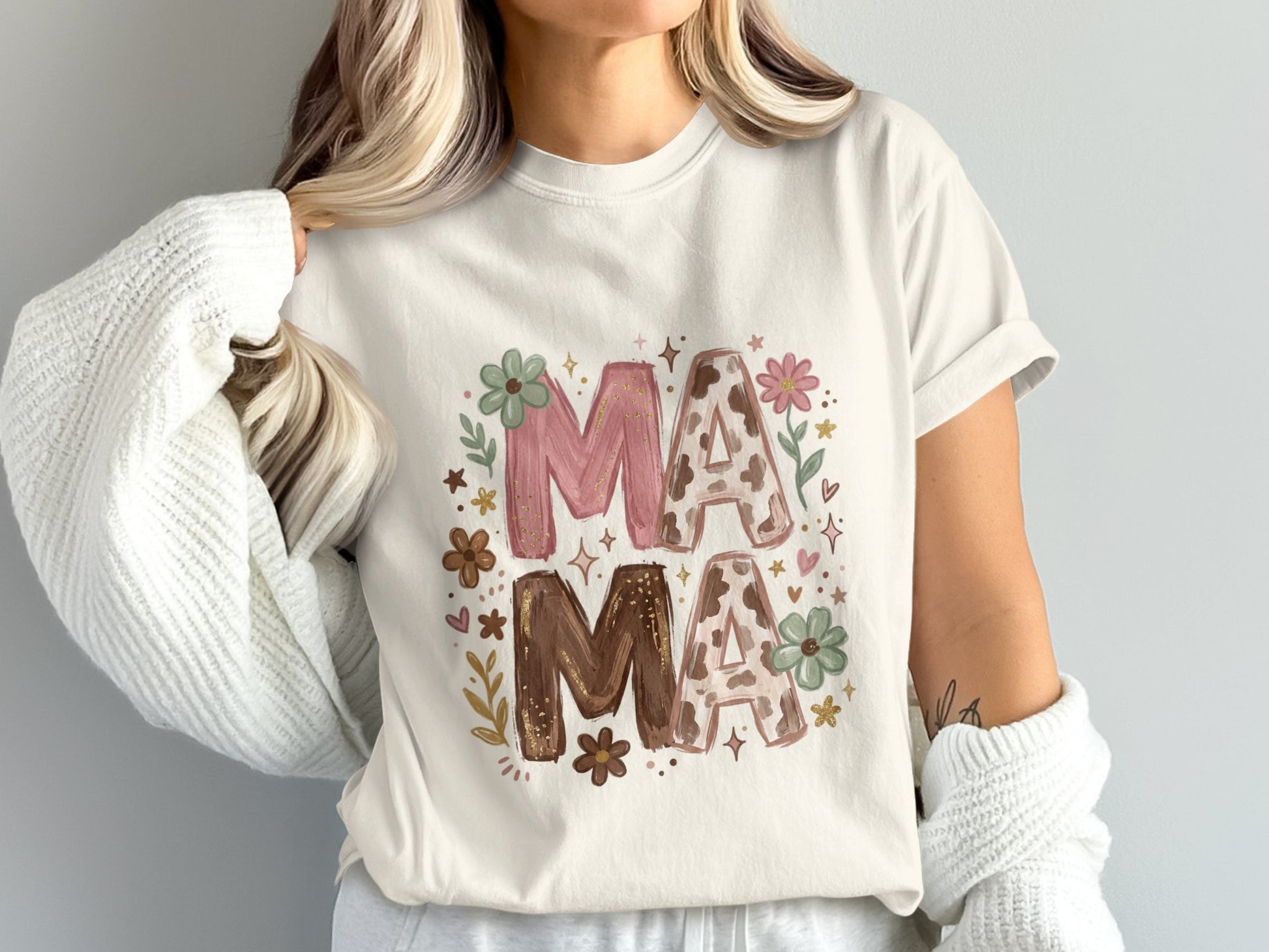 White t-shirt with "MAMA" text in floral and leopard print.