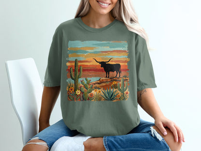 Green t-shirt with desert scene featuring a bull and cacti.