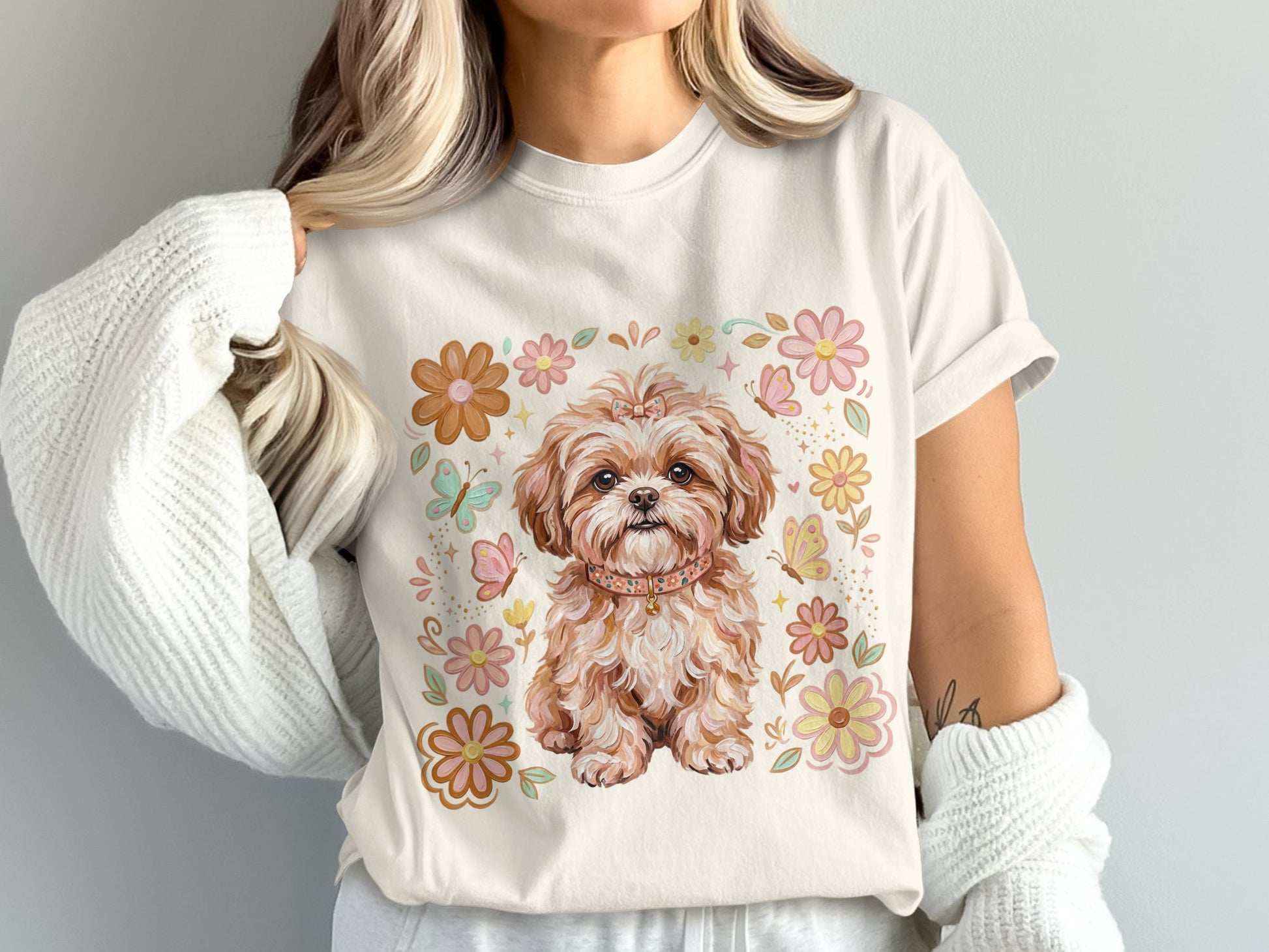 Cream t-shirt with a Shih Tzu puppy surrounded by flowers and butterflies.