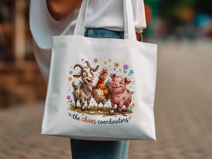White tote bag with cartoon goat, chicken, and pig saying "The Chaos Coordinators."
