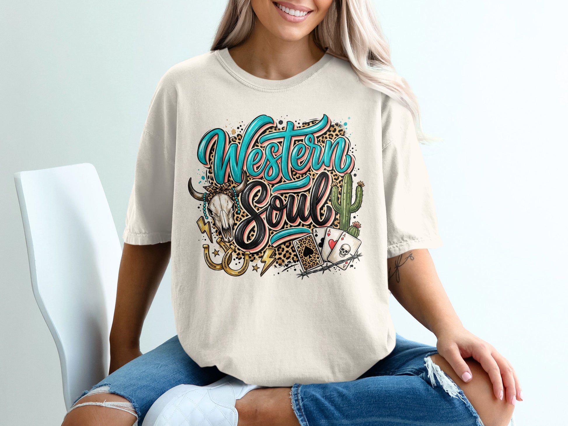 Cream t-shirt with "Western Soul" text, skull, cacti, and playing cards.
