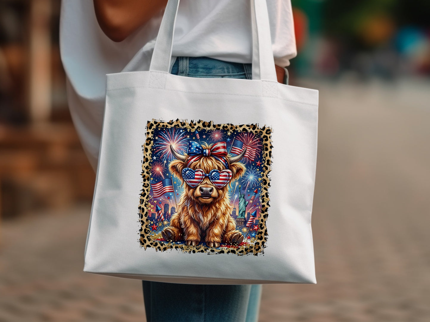 Highland cow wearing heart-shaped sunglasses, fireworks, and patriotic headband on tote bag.