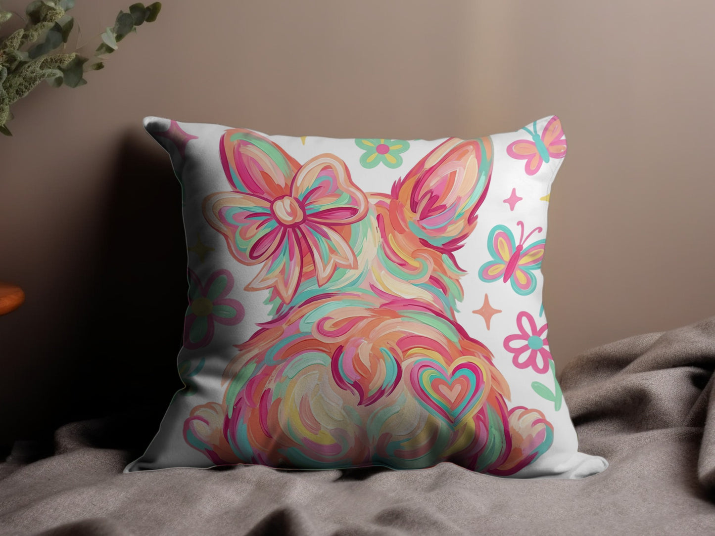 Fluffy bunny with heart and butterflies design on a decorative pillow.