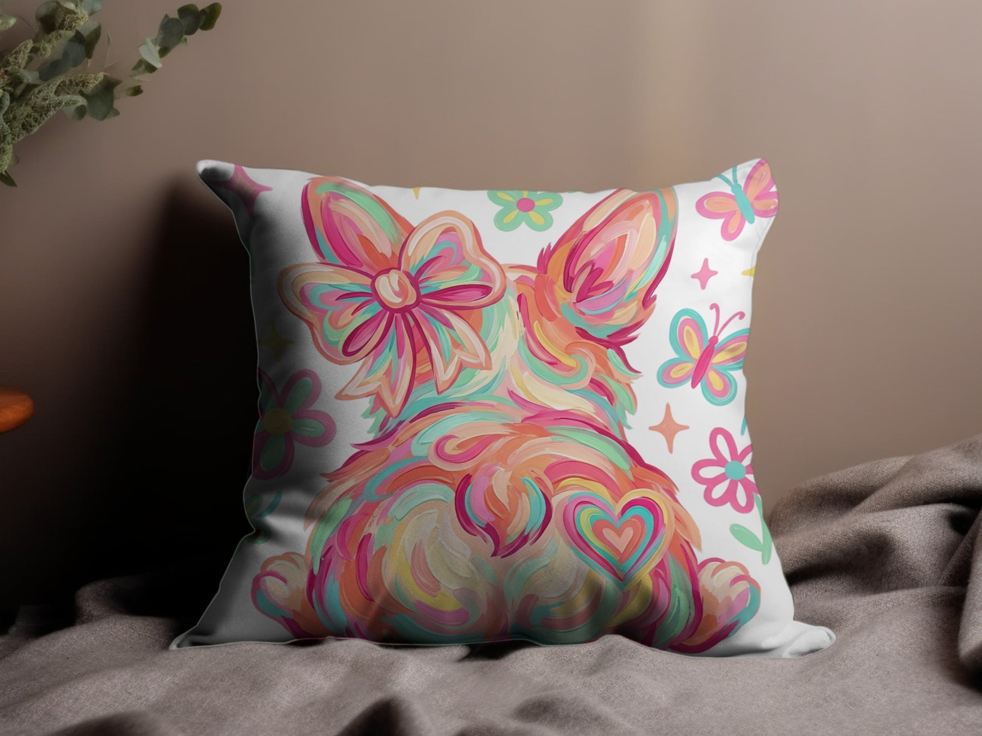 Fluffy bunny with heart and butterflies design on a decorative pillow.