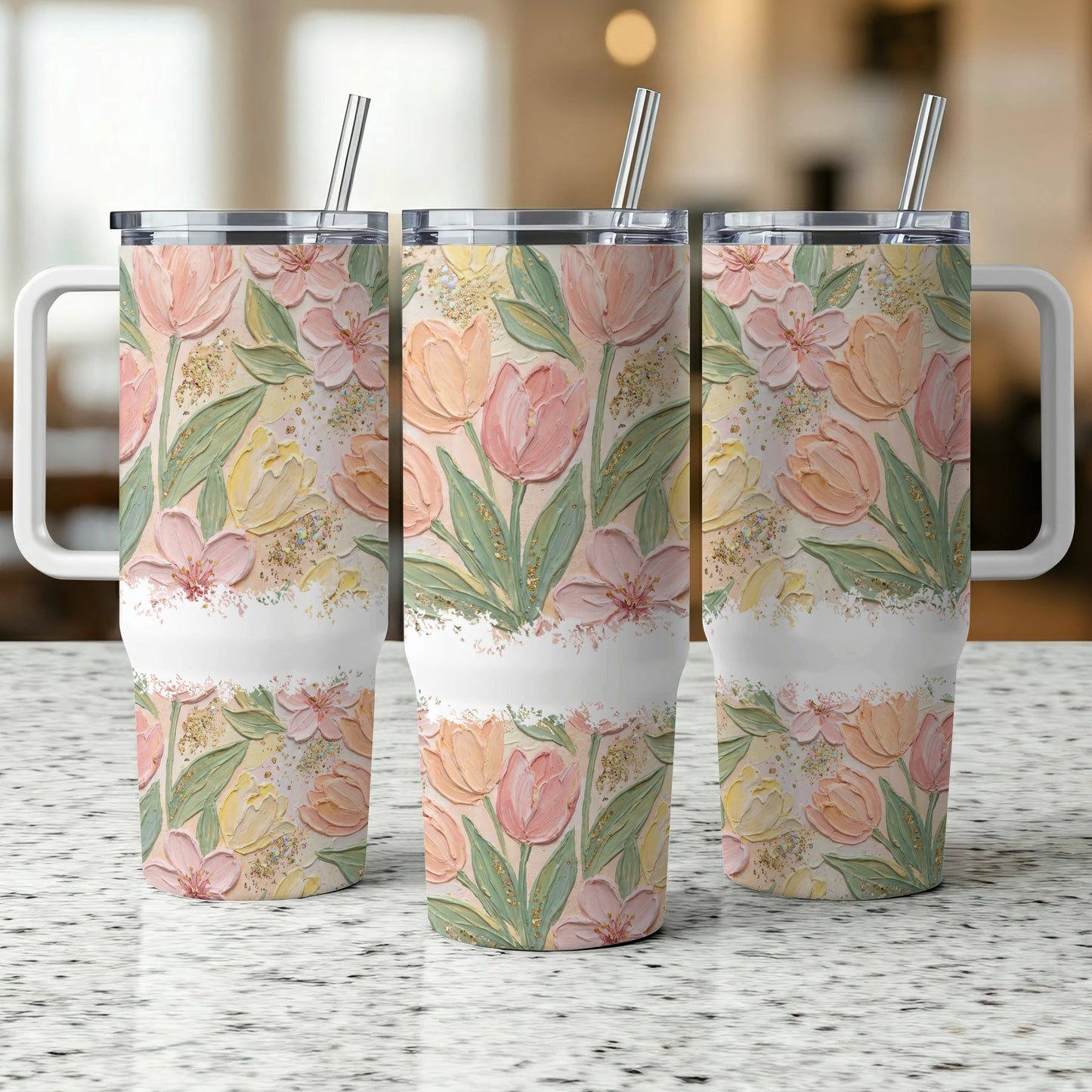 Three floral tumblers with tulips, watercolor style, on a speckled countertop.